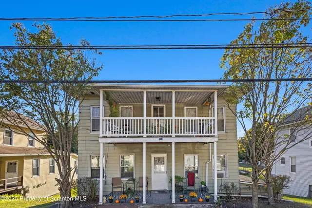 a front view of a building with glass windows and door