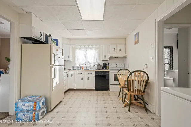 a bathroom with a sink a toilet and shower curtain