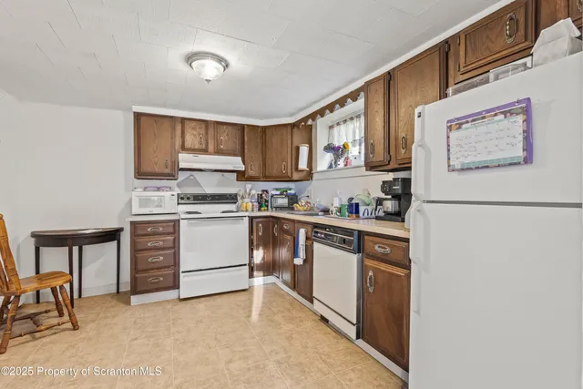 a kitchen with stainless steel appliances granite countertop a refrigerator sink and cabinets