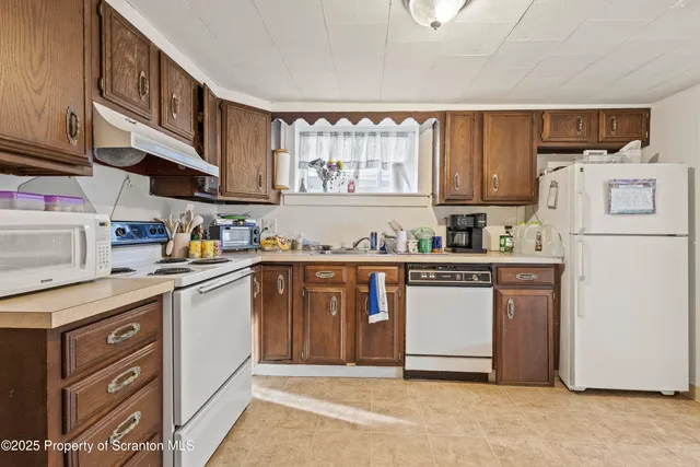 a kitchen with a refrigerator and a stove