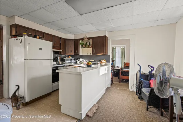 a kitchen with stainless steel appliances a refrigerator sink and cabinets
