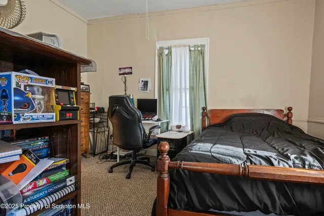 a bedroom with a bed and a chair