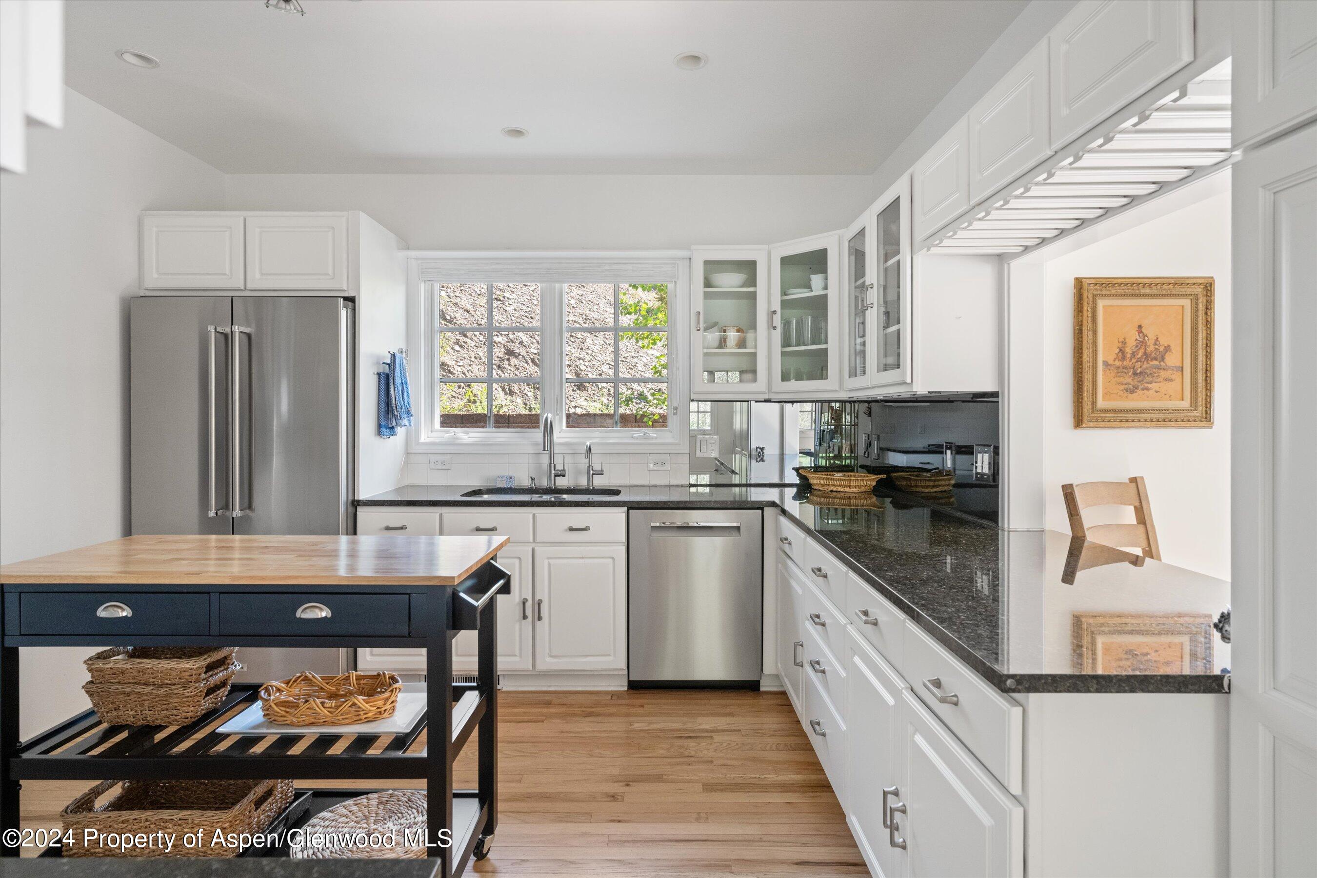 407 Gateway Road Snowmass, CO 81654 - Photo 11 of 37 a kitchen with stainless steel appliances granite countertop a stove a sink and a refrigerator