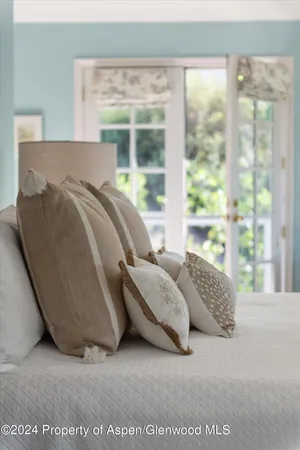 a bed sitting in a bedroom next to a window