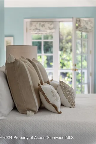 a bed sitting in a bedroom next to a window