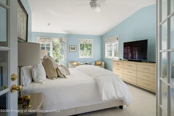 a bedroom with a bed and a flat screen tv
