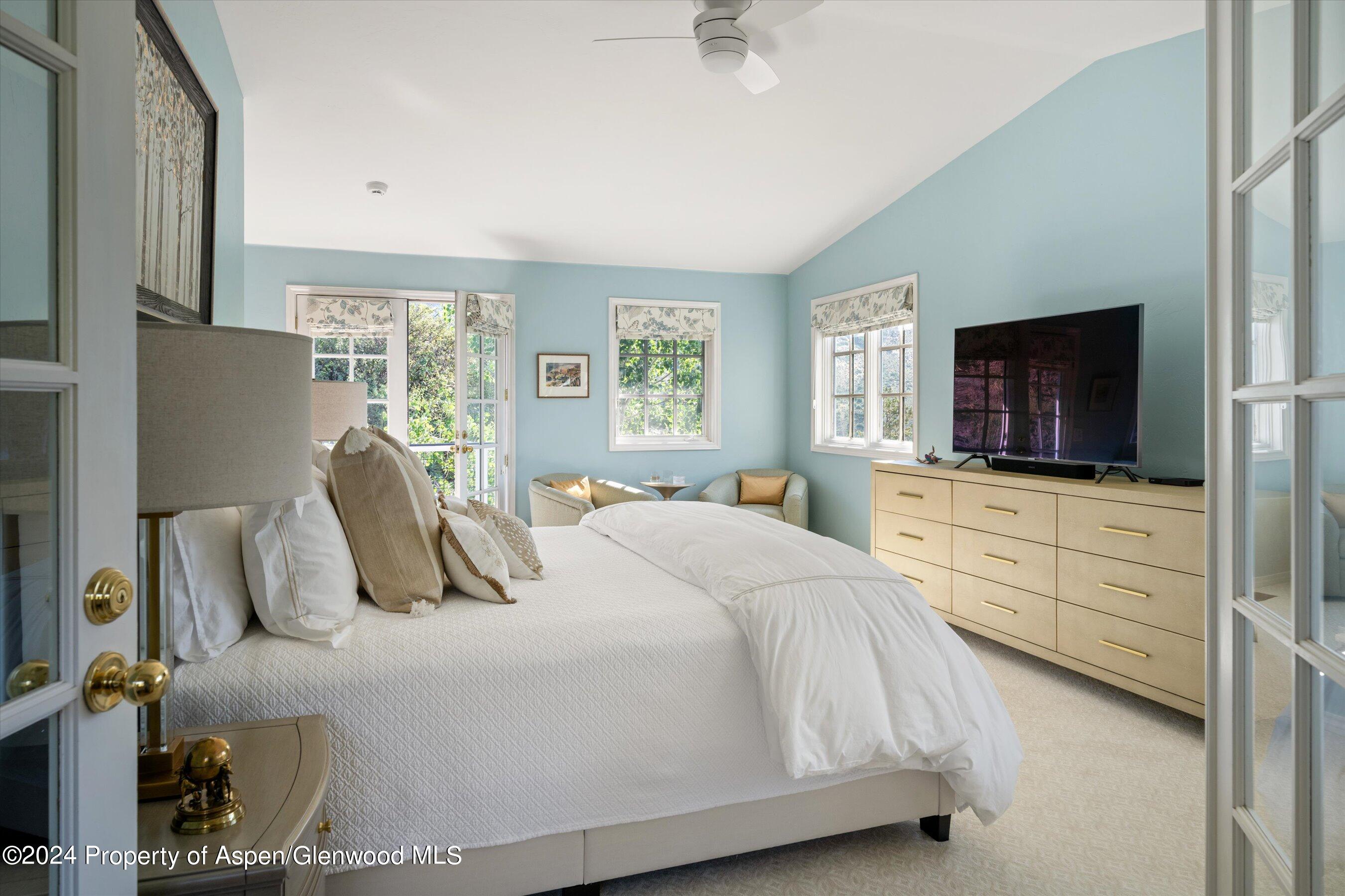 407 Gateway Road Snowmass, CO 81654 - Photo 16 of 37 a bedroom with a bed and a flat screen tv