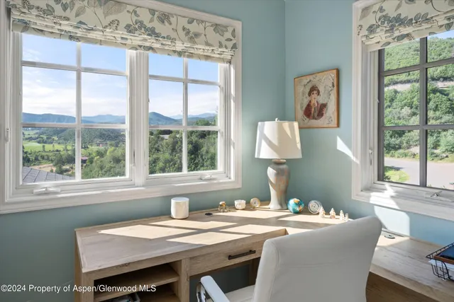 a dining room with a window table and chairs