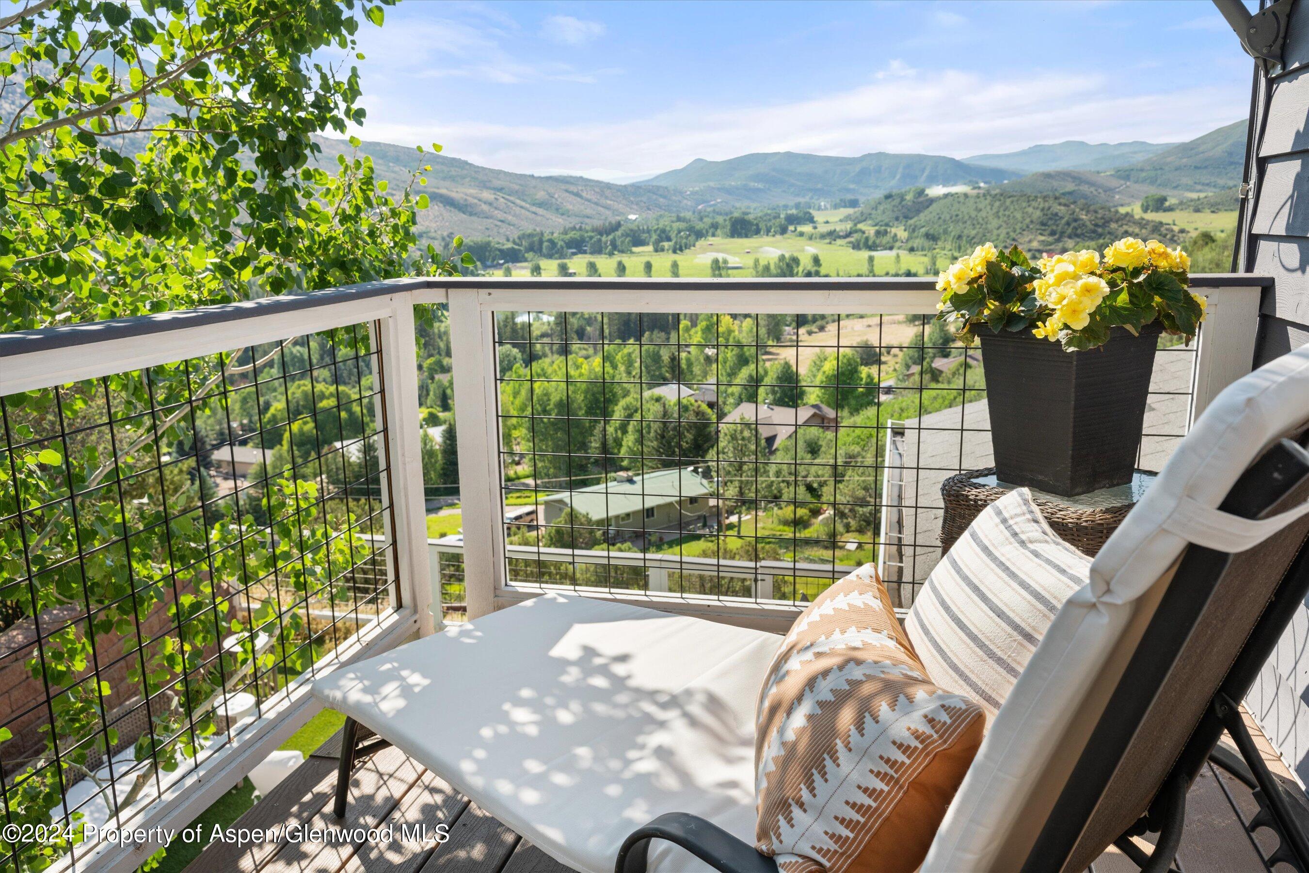 407 Gateway Road Snowmass, CO 81654 - Photo 21 of 37 a view of a city from a balcony with furniture