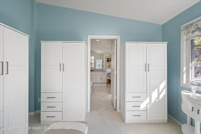 a spacious bathroom with a granite countertop sink mirror and bathtub