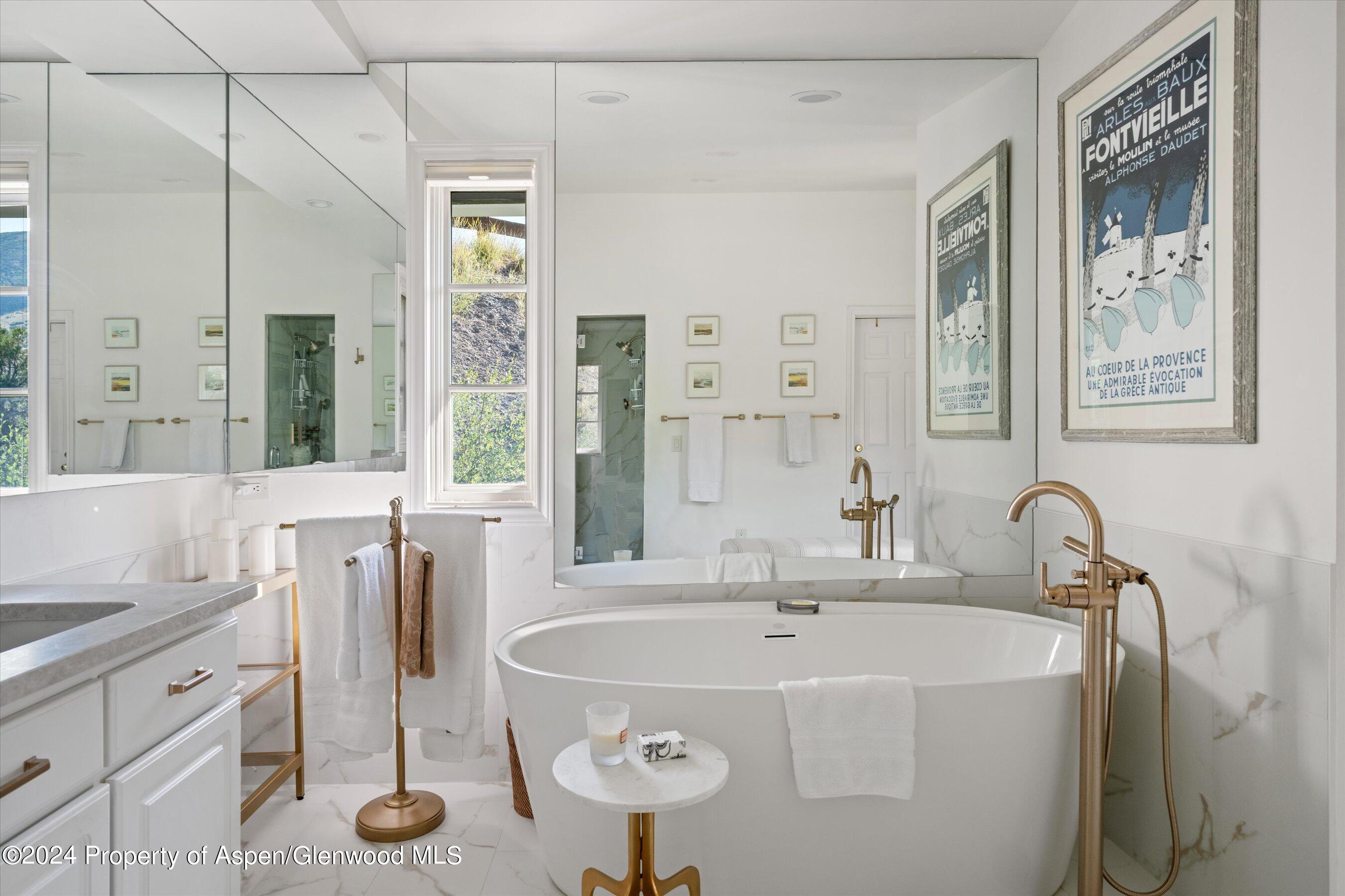 407 Gateway Road Snowmass, CO 81654 - Photo 25 of 37 a bathroom with a tub sink and mirror