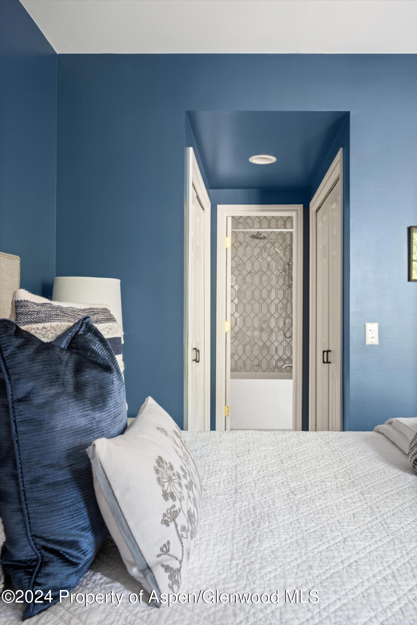 407 Gateway Road Snowmass, CO 81654 - Photo 27 of 37 a bedroom with a bed and wooden floor