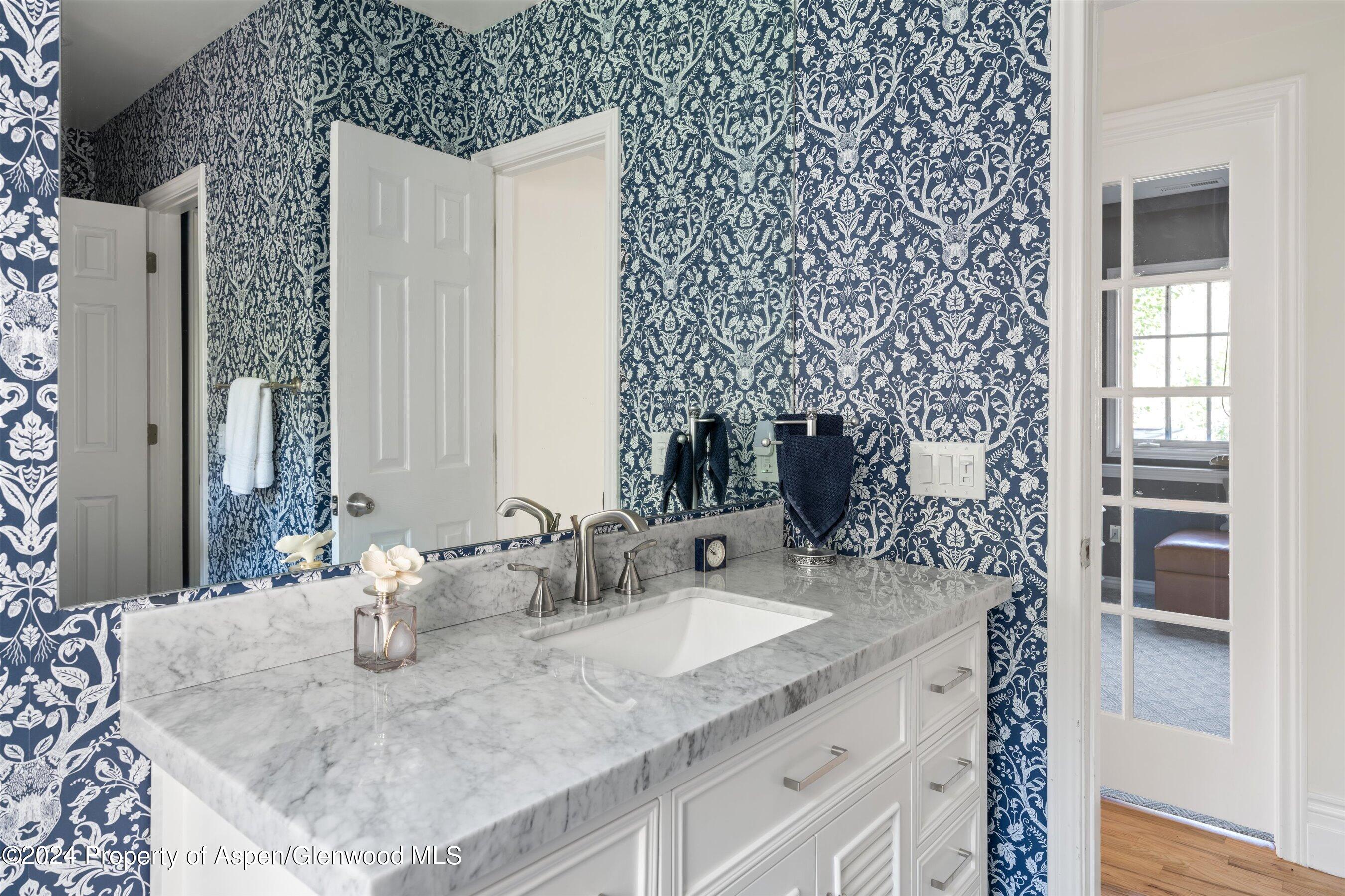 407 Gateway Road Snowmass, CO 81654 - Photo 29 of 37 a bathroom with a granite countertop sink and a mirror