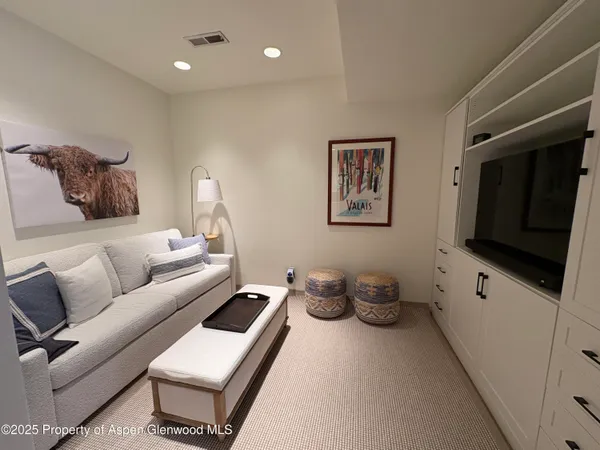 a living room with furniture and a lamp