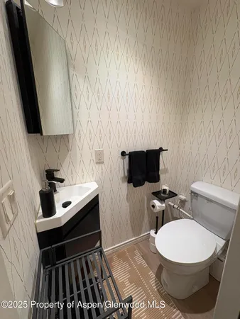 a utility room with sink dryer and washer