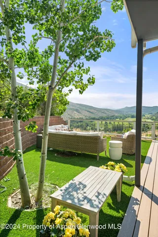 a view of a house with couches chairs and a yard
