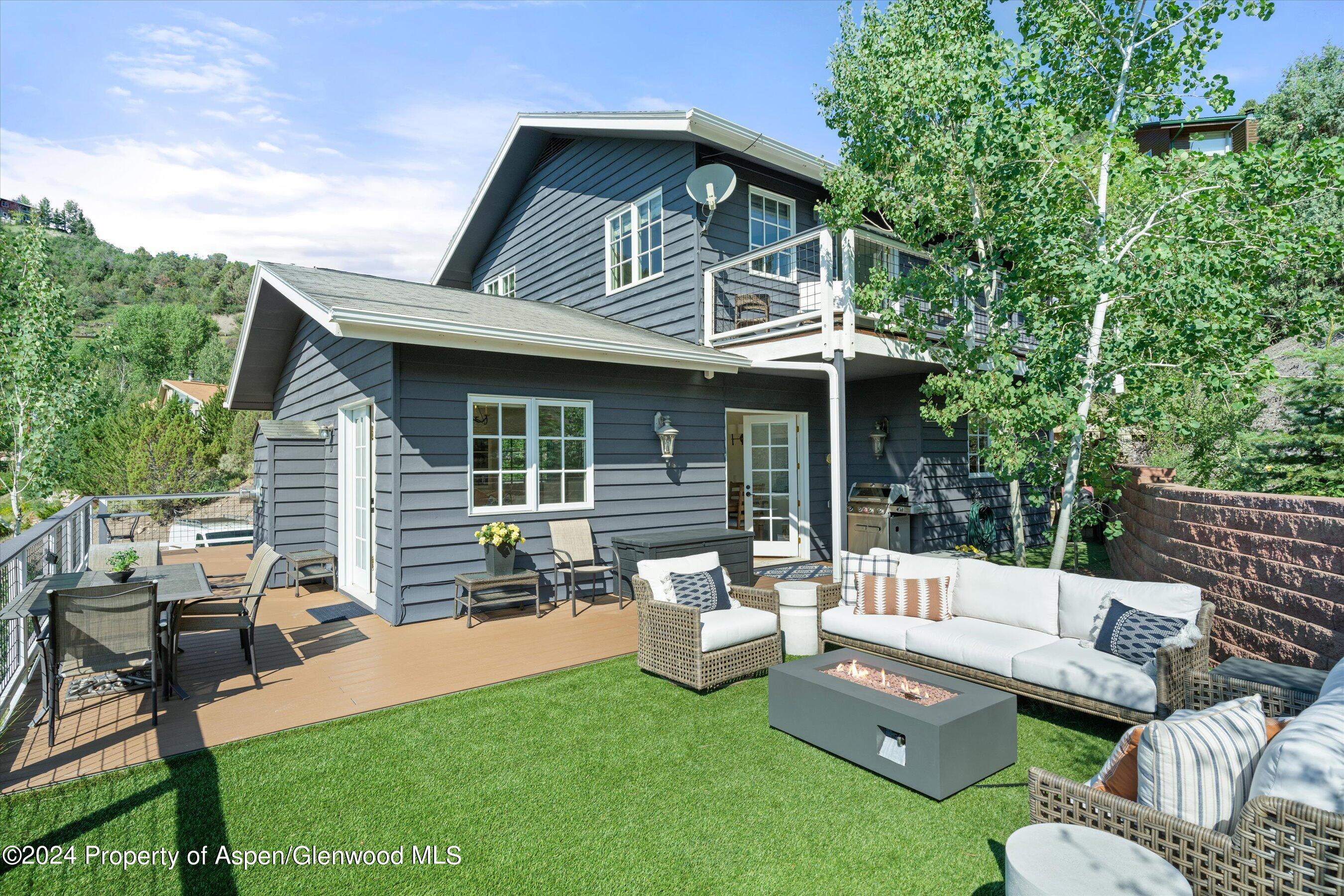 407 Gateway Road Snowmass, CO 81654 - Photo 36 of 37 a view of a house with couches chairs and a yard