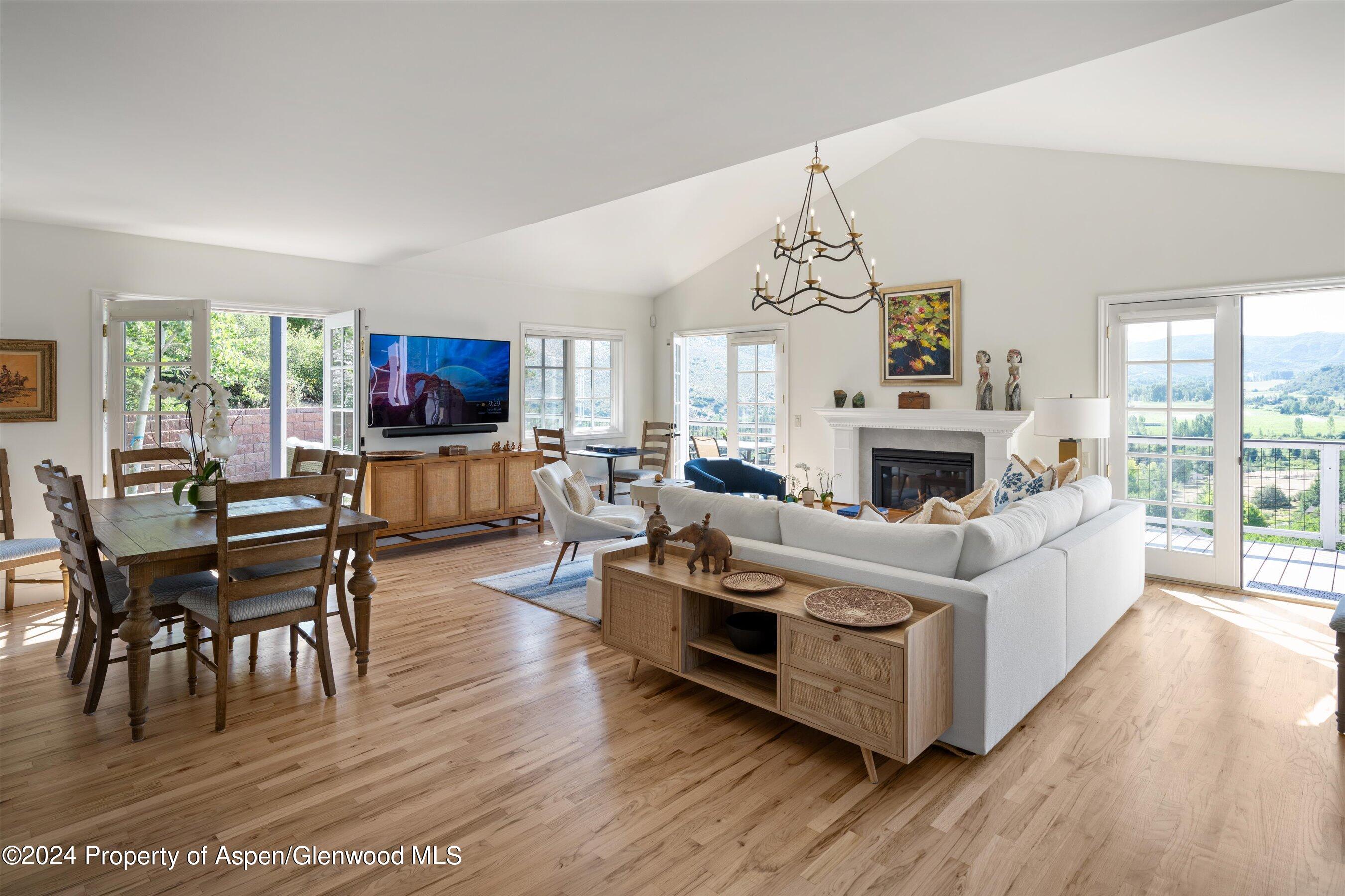 407 Gateway Road Snowmass, CO 81654 - Photo 5 of 37 a living room with furniture a fireplace and a flat screen tv
