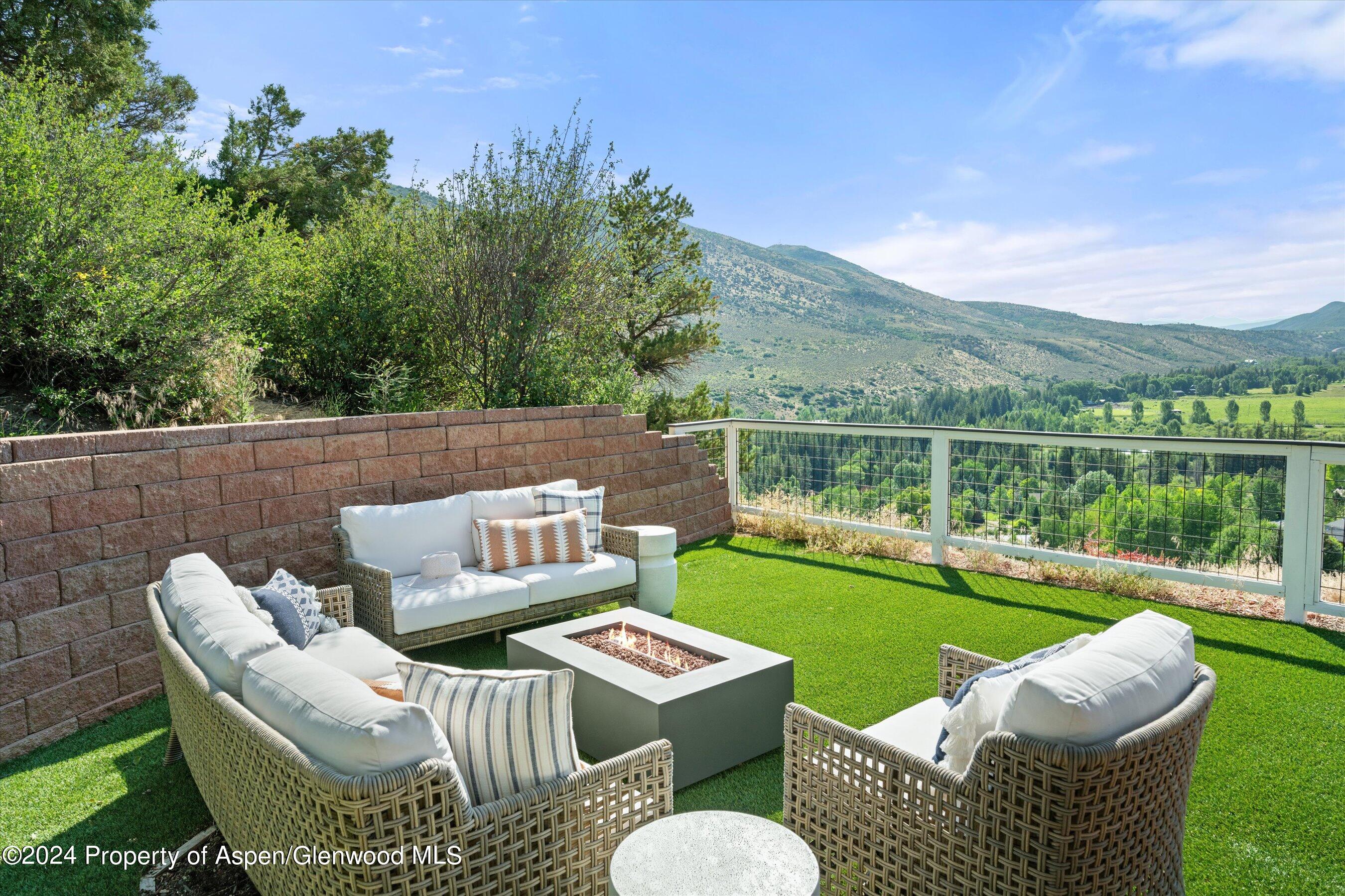 407 Gateway Road Snowmass, CO 81654 - Photo 7 of 37 a view of a patio with couches chairs and a table