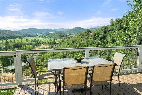 a view of a chairs and table on the deck
