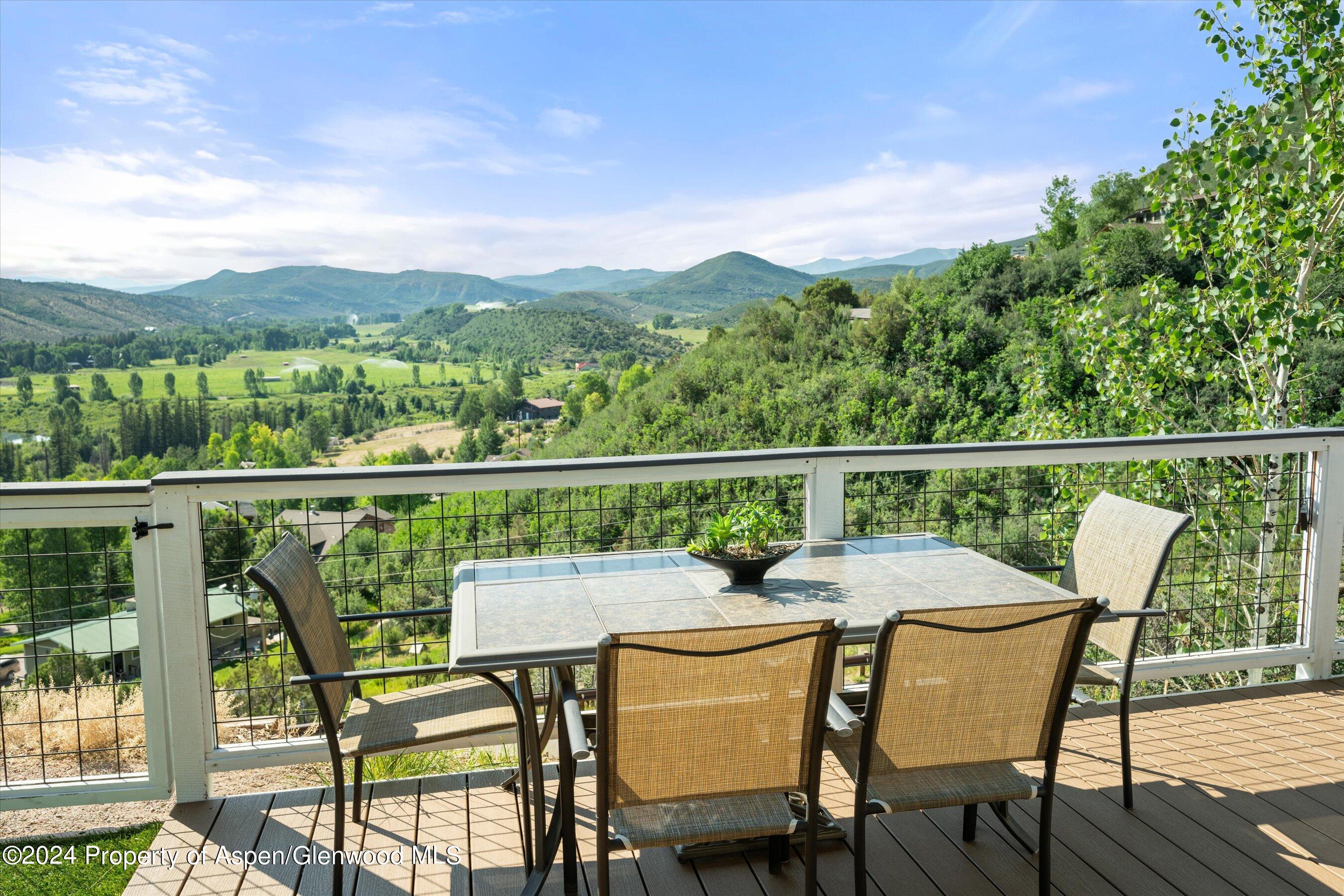 407 Gateway Road Snowmass, CO 81654 - Photo 8 of 37 a view of a chairs and table on the deck