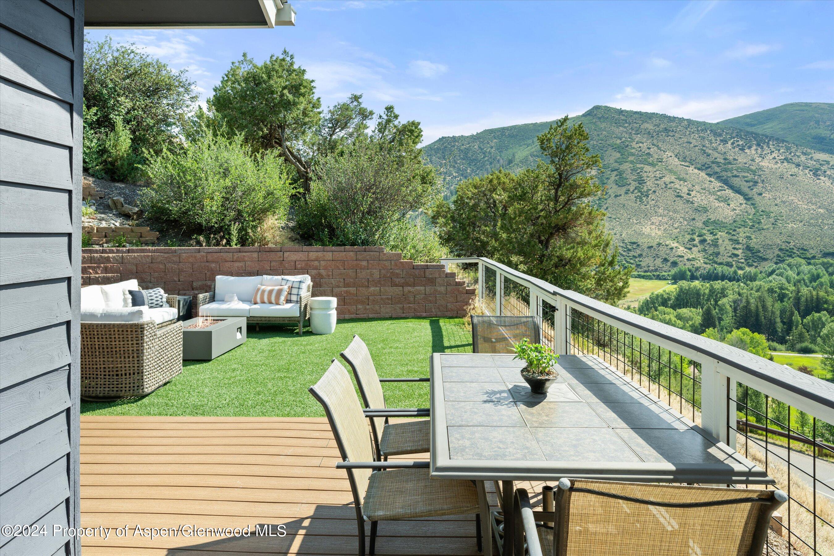 407 Gateway Road Snowmass, CO 81654 - Photo 9 of 37 a balcony with wooden floor table and chairs