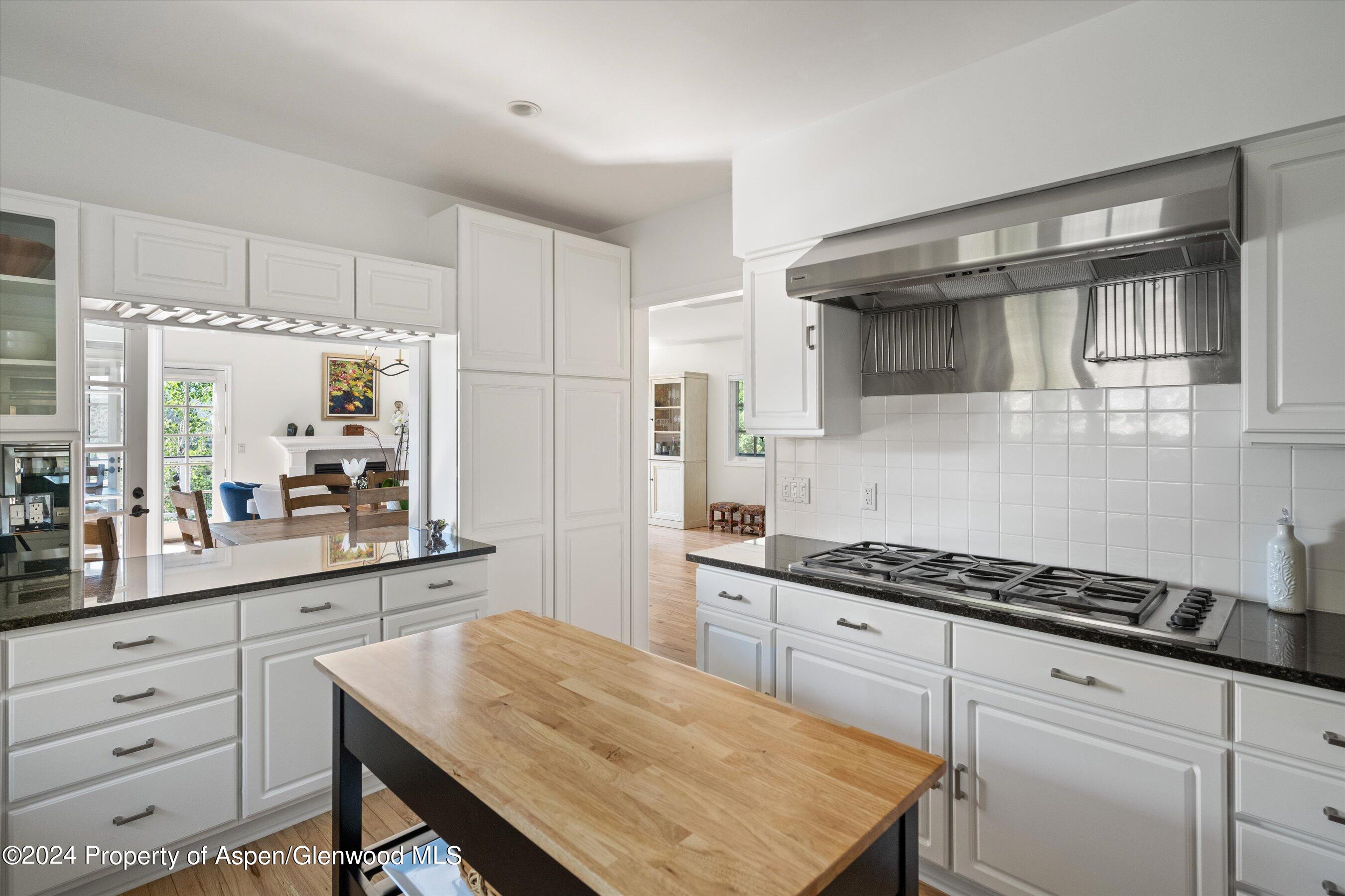 407 Gateway Road Snowmass, CO 81654 - Photo 10 of 37 a kitchen with white cabinets and appliances