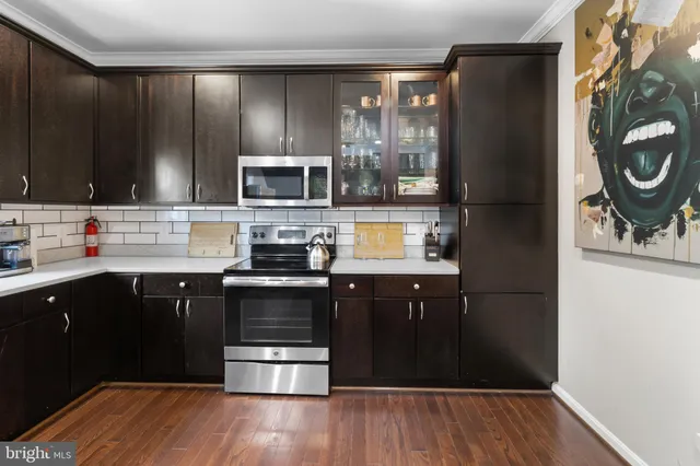 a kitchen with stainless steel appliances granite countertop a stove and a refrigerator