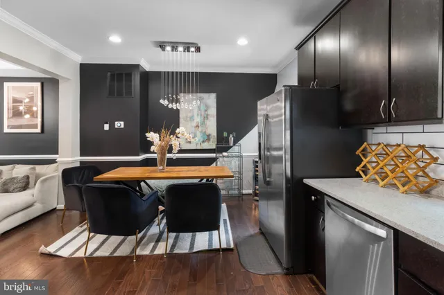 a view of a dining room with furniture a rug and wooden floor