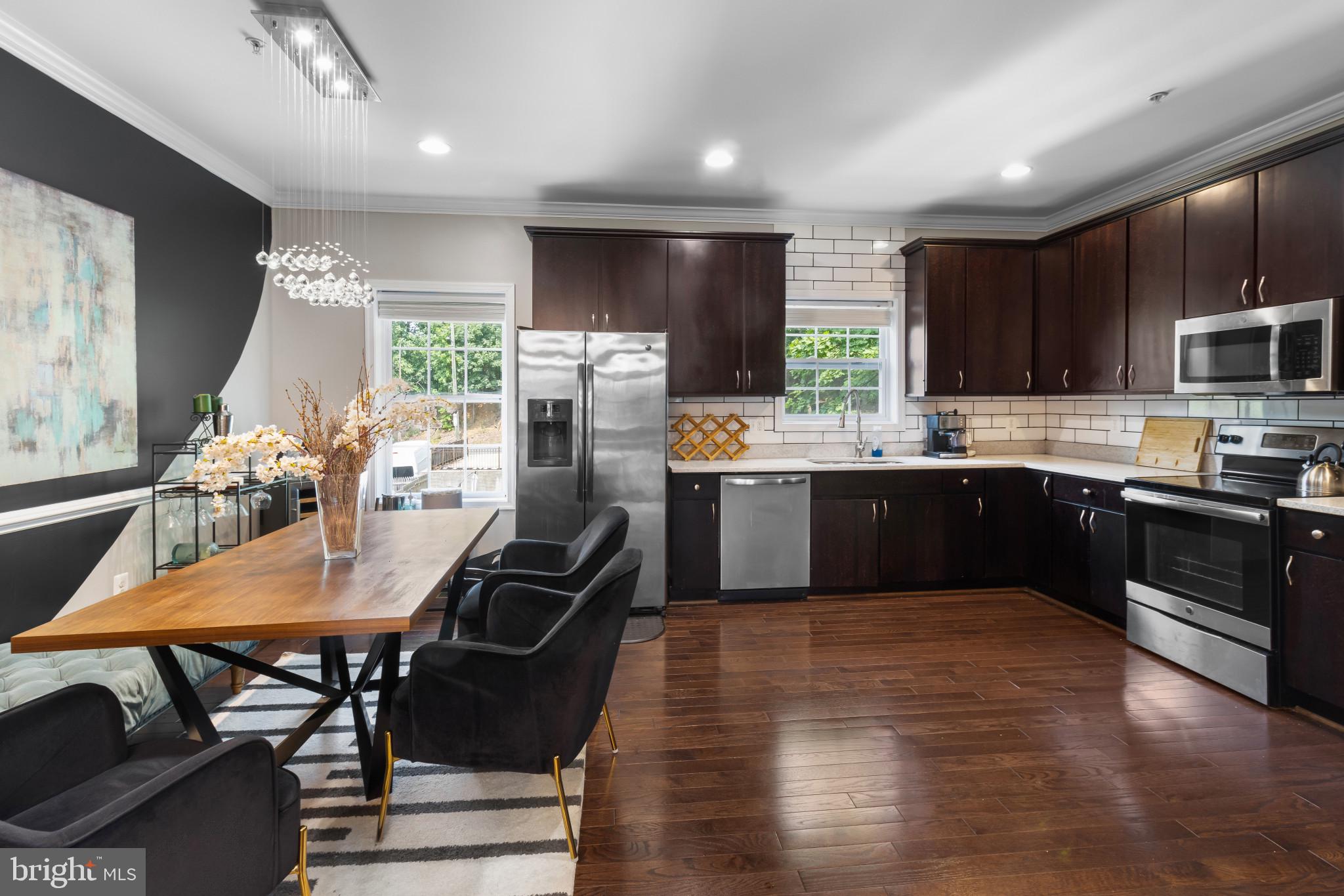 1778 W Street Southeast Washington, DC 20020 - Photo 14 of 44 a kitchen with stainless steel appliances granite countertop a stove refrigerator sink microwave and cabinets
