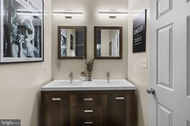 a bathroom with a double vanity sink and a mirror