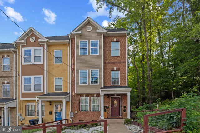 a front view of a residential apartment building with a yard