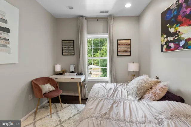 a bedroom with a bed and a window