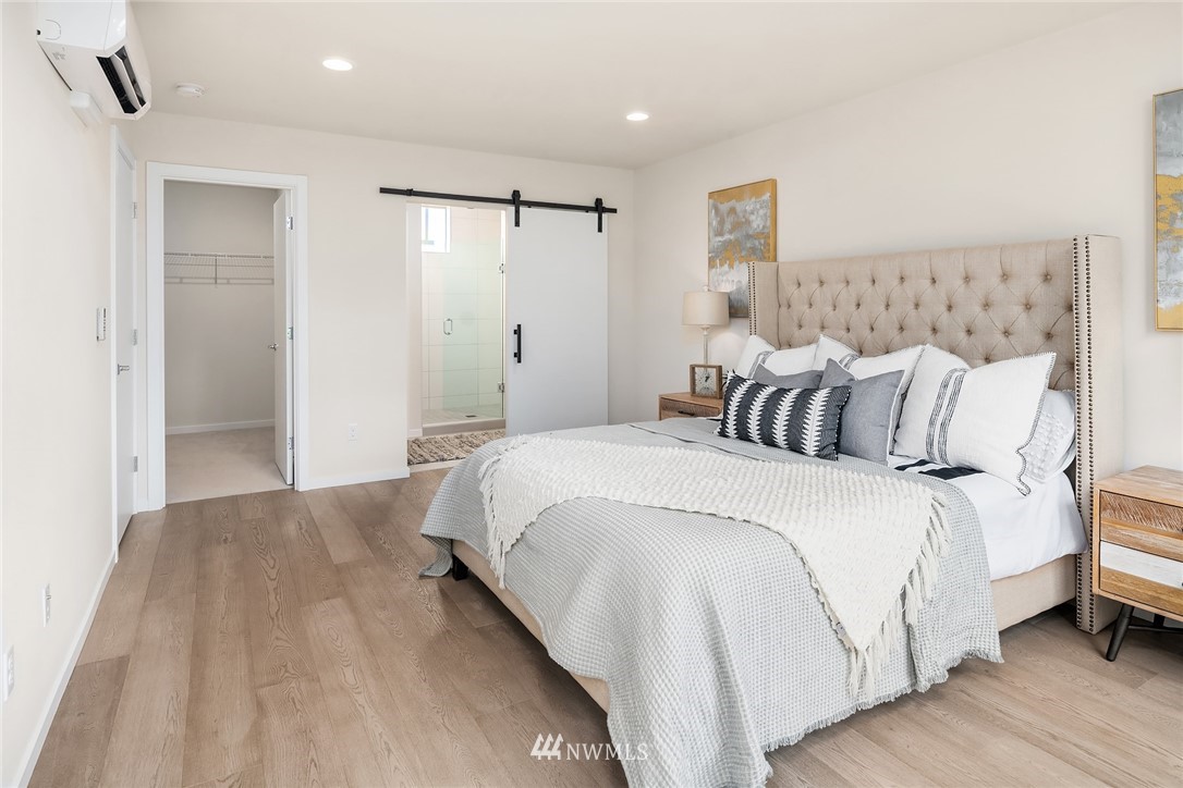 8370 Loyal Way Northwest, Unit B Seattle, WA 98117 - Photo 11 of 19 a bedroom with a bed and a mirror