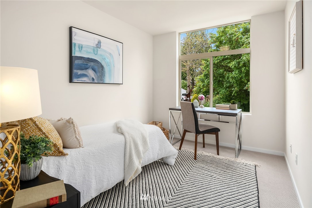 8370 Loyal Way Northwest, Unit B Seattle, WA 98117 - Photo 13 of 19 a bedroom with a bed and a large window