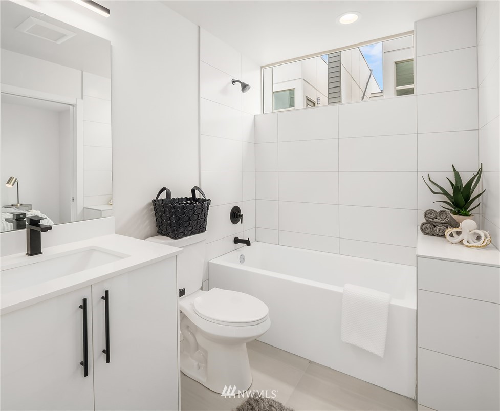 8370 Loyal Way Northwest, Unit B Seattle, WA 98117 - Photo 15 of 19 a bathroom with a sink a toilet and bathtub