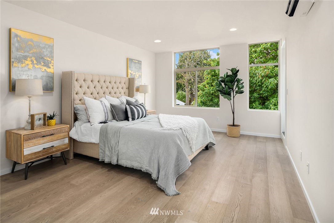 8370 Loyal Way Northwest, Unit B Seattle, WA 98117 - Photo 10 of 19 a bedroom with a bed and large window