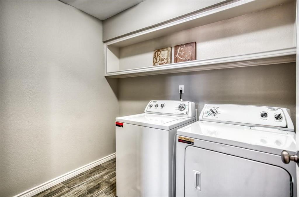 5421 North Briar Ridge Circle McKinney, TX 75072 - Photo 24 of 27 Laundry room with dark wood-style flooring, washer and clothes dryer, and a textured wall