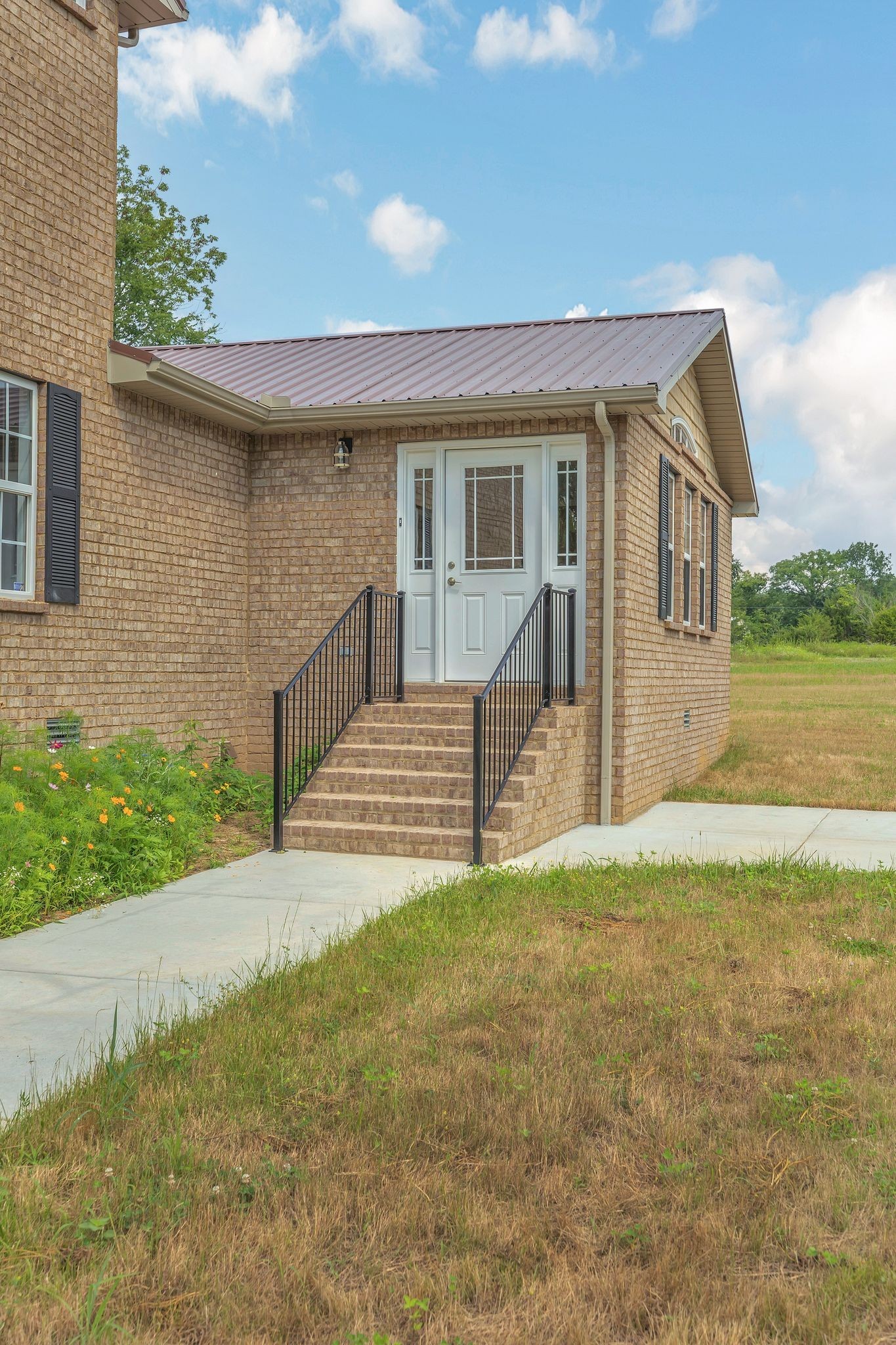 5065 Craddock Road Lascassas, TN 37085 - Photo 4 of 51 a front view of a house with a garden and yard