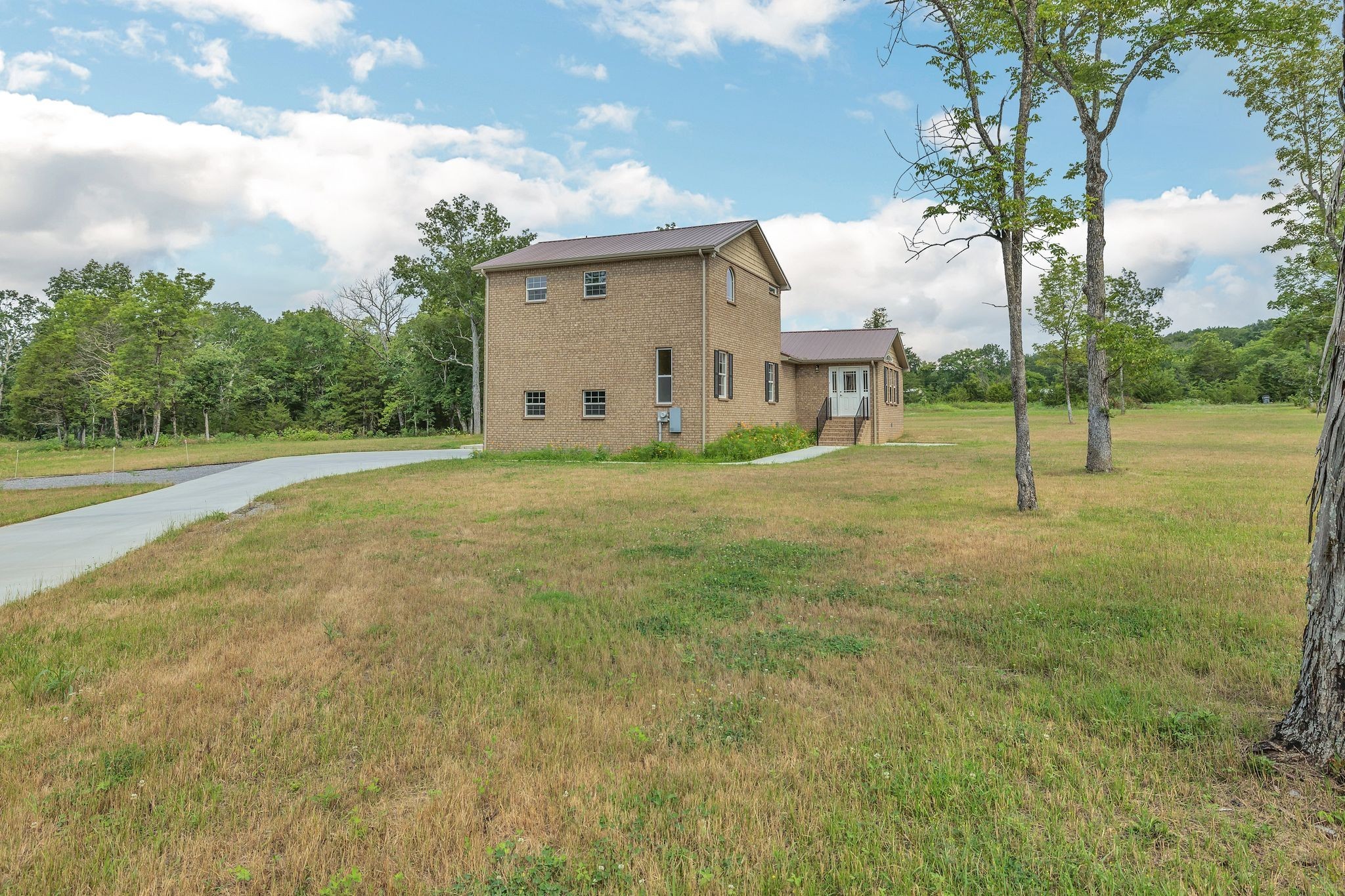 5065 Craddock Road Lascassas, TN 37085 - Photo 6 of 51 a large house with a big yard and large trees