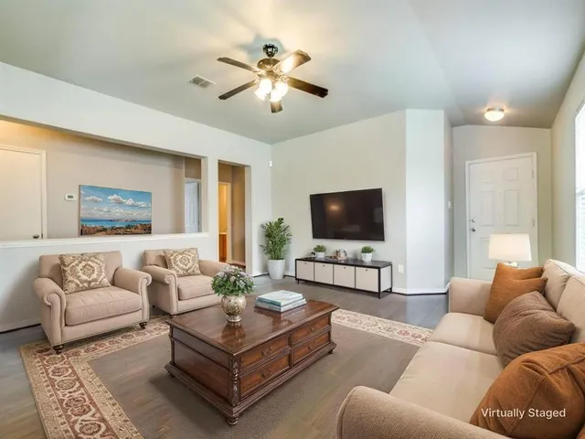 a living room with furniture and a flat screen tv