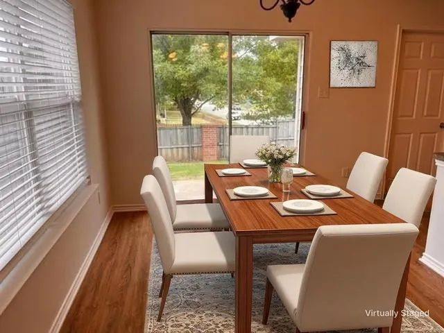 a dining room with furniture and wooden floor