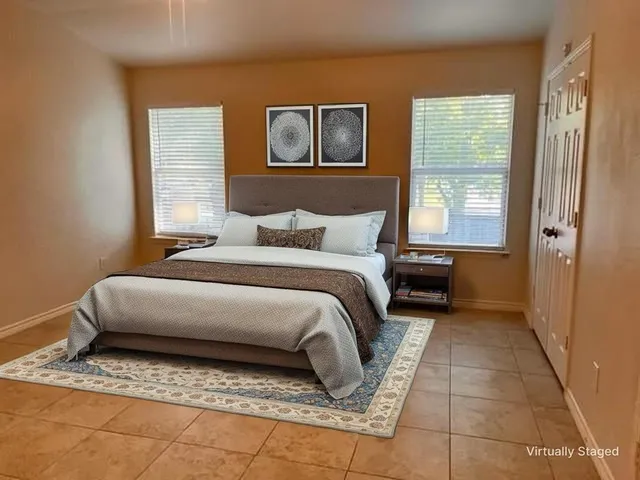 a bedroom with a bed and a painting on the wall