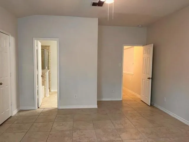 a view of an empty room and a window