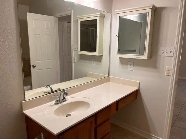 a bathroom with a sink and a mirror