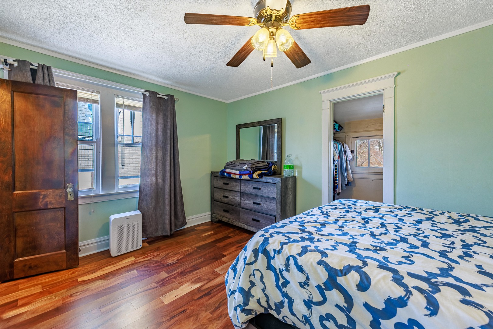 410 Repton Road Riverside, IL 60546 - Photo 15 of 30 a bedroom with a bed and a chandelier