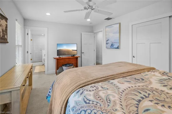 a bedroom with bed and wooden floor