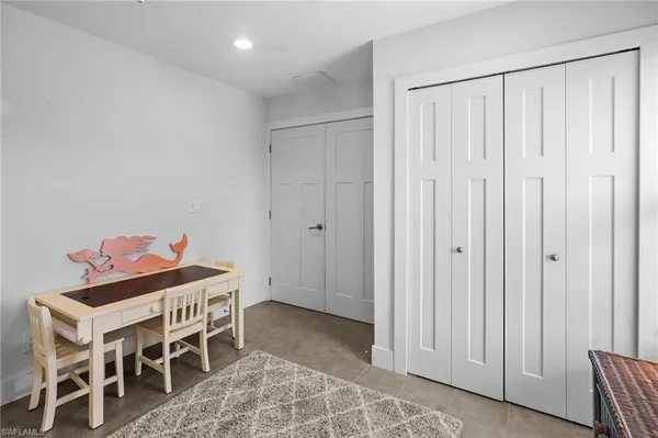 a view of a patio with table and chairs and floor to ceiling window with wooden floor