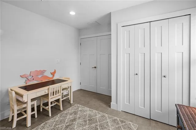 a view of a patio with table and chairs and floor to ceiling window with wooden floor