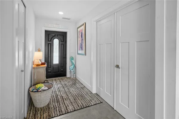 a kitchen with kitchen island granite countertop a stove a sink a microwave a dining table and chairs